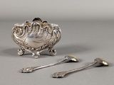 two spoons and a spoon rest on a table