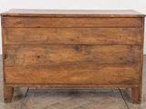 an old wooden chest of drawers on a parquet floor