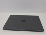 the laptop is sitting on a table with a white background