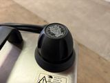 a close up of a black knob on a toaster