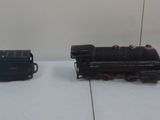 four small toy trains sitting on a white surface