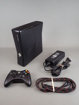 a video game console and a game controller on a table