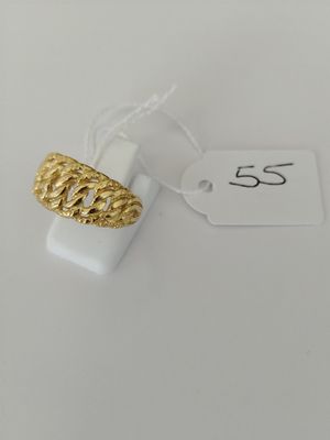 a close up of a gold ring on a white surface