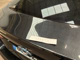 a sticker on the hood of a car that is parked in a parking lot