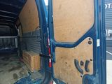a blue van with a wooden door open in a parking lot