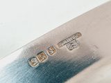 a close up of a knife on a white surface