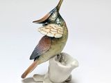 porcelain figurine of a bird perched on a white flower