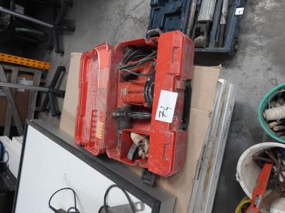 a red tool box sitting on top of a pile of tools