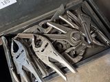 a metal tool box filled with various tools on the floor