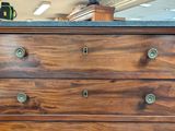 a wooden dresser with four drawers and a granite top