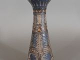 a blue and white vase sitting on a table