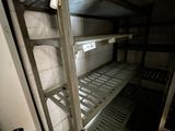 a metal shelf in the corner of a room