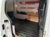 a white van that has a bed in the back of it