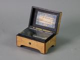 a small wooden box with a musical box inside of it