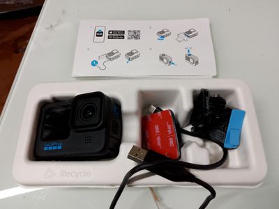a white box with a camera and a charger attached to it