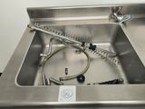 a stainless steel sink with a hose in it
