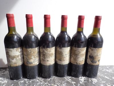 six bottles of wine are lined up in a row on a table