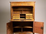an old wooden desk with drawers and a laptop on top