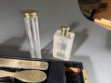 a box with a pair of scissors, a bottle of perfume, and a pair of scissors