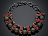 a close up of a necklace on a black background