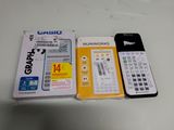 a calculator, a cell phone and a package of cards on a table
