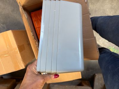 a person holding a briefcase in a cardboard box