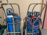 two carts with gas bottles and hoses on them