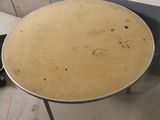 a round table with a metal base in a room