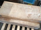 wooden pallets stacked on top of each other in front of a blue door