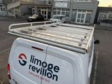 a white van with a roof rack on it in a parking lot
