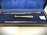 two silverplated knives and a cane in a case