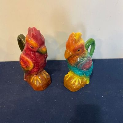 deux figurines représentant des oiseaux colorés sur un fond bleu