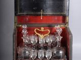 a wooden box with a bunch of wine glasses inside of it