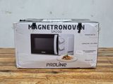 packaging of a white microwave sitting on top of a wooden table
