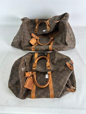 two louis vuittou bags sitting on top of a white table