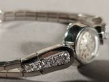 a close up of a wrist watch with diamonds on it