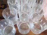 a lot of glasses sitting on a wooden table