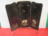 a black screen with flowers on it on a red floor