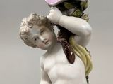 a figurine of a boy with a hat on his head