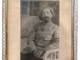 an old picture of a man in a military uniform sitting in a chair