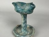 an image of a small blue vase sitting on top of a white table