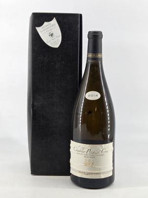 the bottle of wine is next to the black box