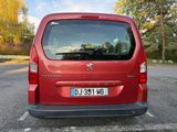 a red van that is parked in a parking lot