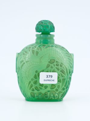 a green glass bottle with a bird on it