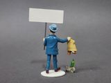 a figurine of a man holding a sign and a dog