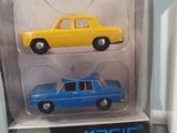 three toy cars that are in a box on a table