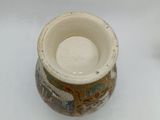 a small vase sitting on a white surface with a white background
