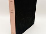 a black book sitting on top of a white table