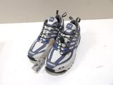 pair of blue and white running shoes on a white surface