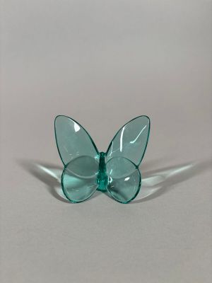 a glass butterfly that is sitting on top of a table
